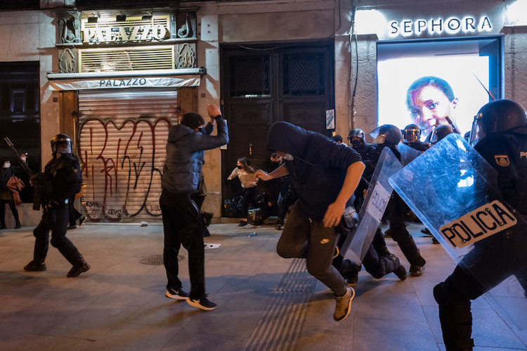 Riot police beating protesters during clashes in a Riot police beating protesters during clashes in a